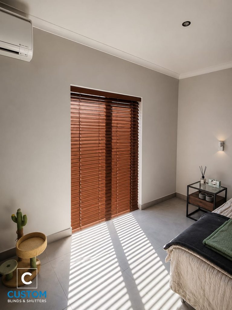 Made-to-measure wooden Venetian blinds installed in a bedroom